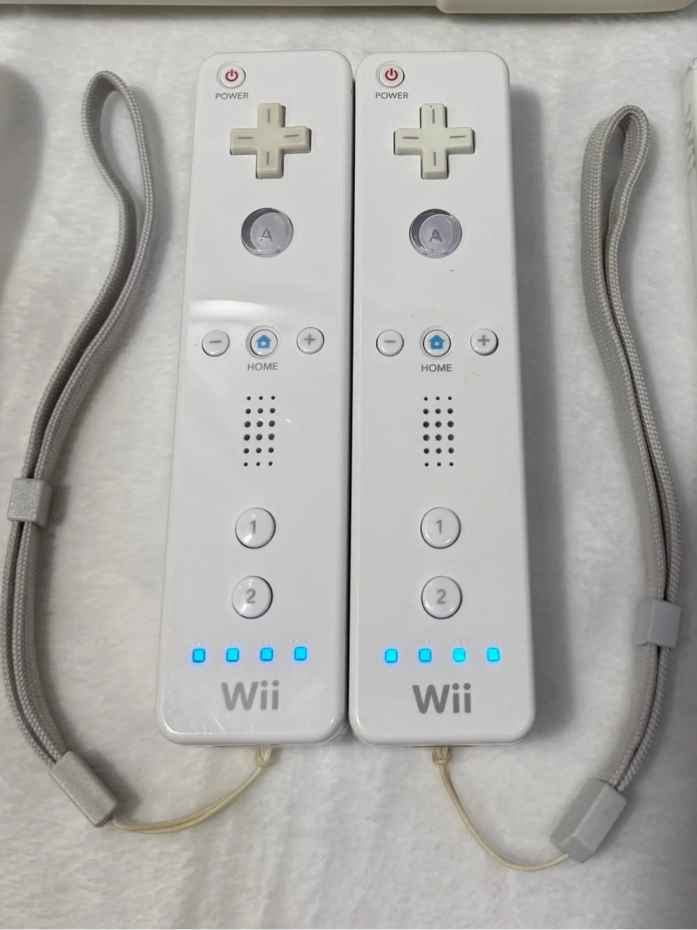 Nintendo Wii console with 2 remotes, 1 silicone sleeve & Nerf sports attachments